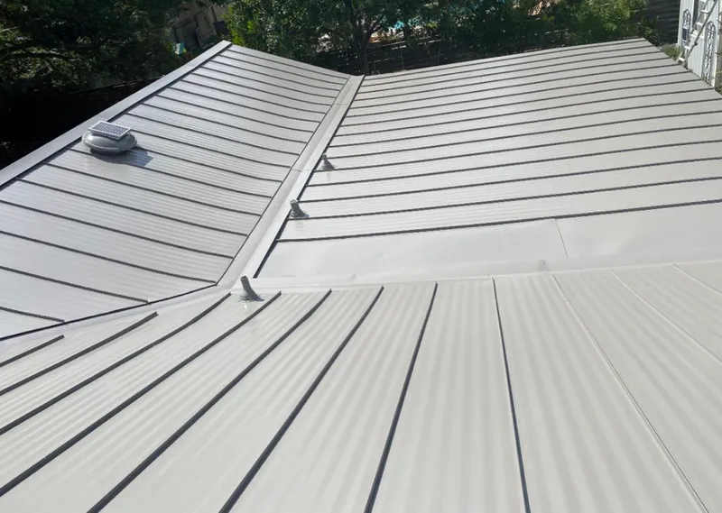 Solar attic fan installed on a metal roof for Roof Ventilation in Asbury Lake